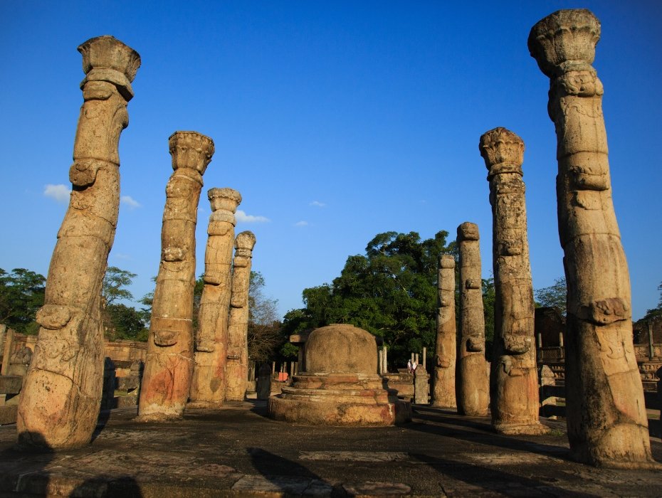 Ancient carved stone pillars surrounding Buddhist stupa at UNESCO World Heritage Site in Anuradhapura, Sri Lanka